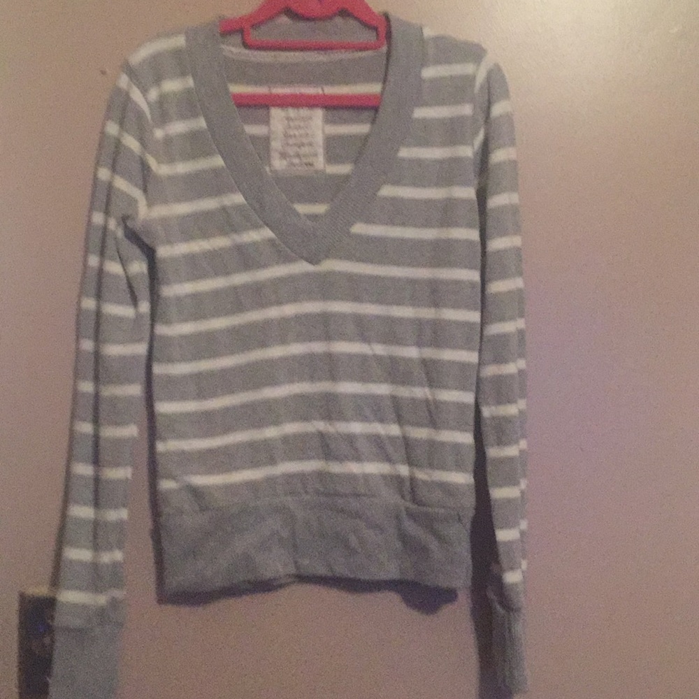 Gray and white striped V-neck sweater